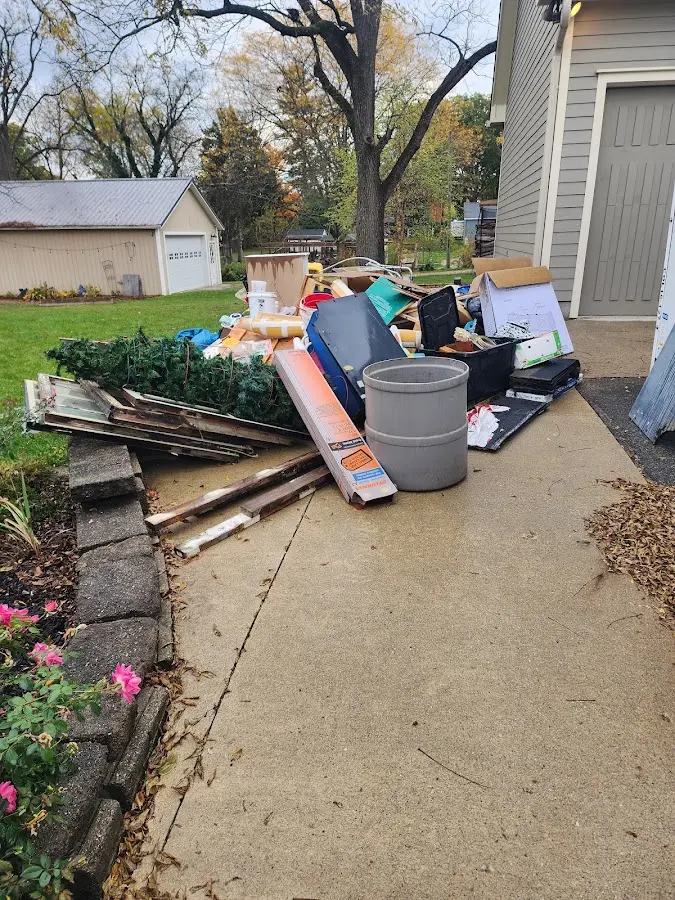 Dumpster being loaded with debris for 10 Yard Dumpster Rental in Jurupa Valley